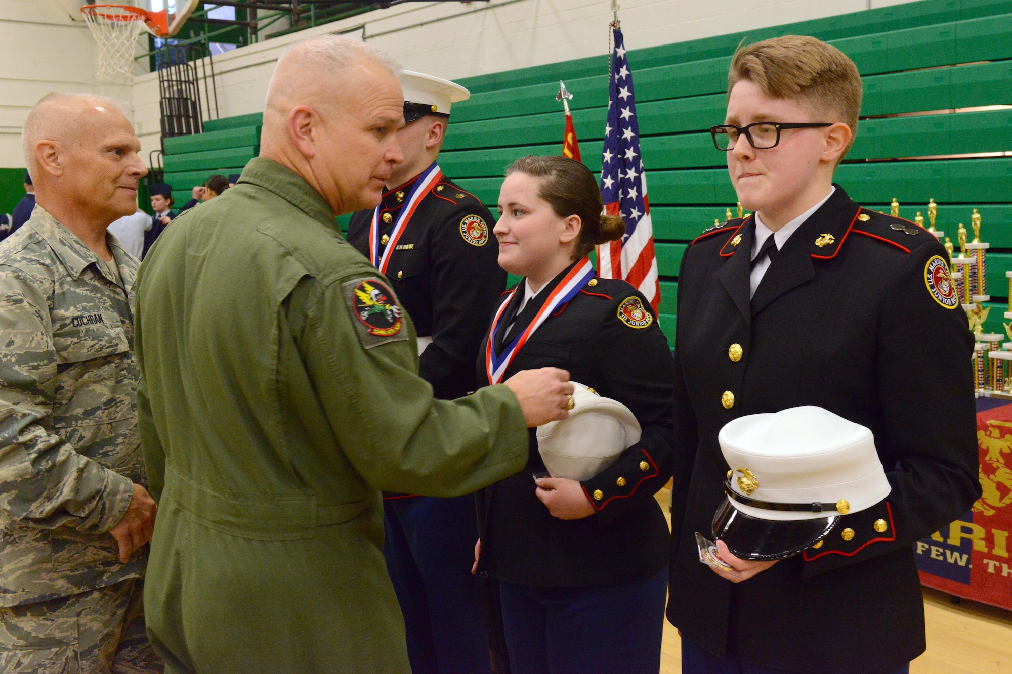 Brig. Gen. Drew Dehaes and Chief MSgt. Timothy Cochran award and congratulate the winners of the knockout competition at the JROTC competition at North High School, Des Moines, Iowa on April 1, 2017. The knockout competition tests the cadet’s ability to respond quickly and precisely to drill commands. (U.S. Air National Guard photo by Airman Katelyn Sprott)