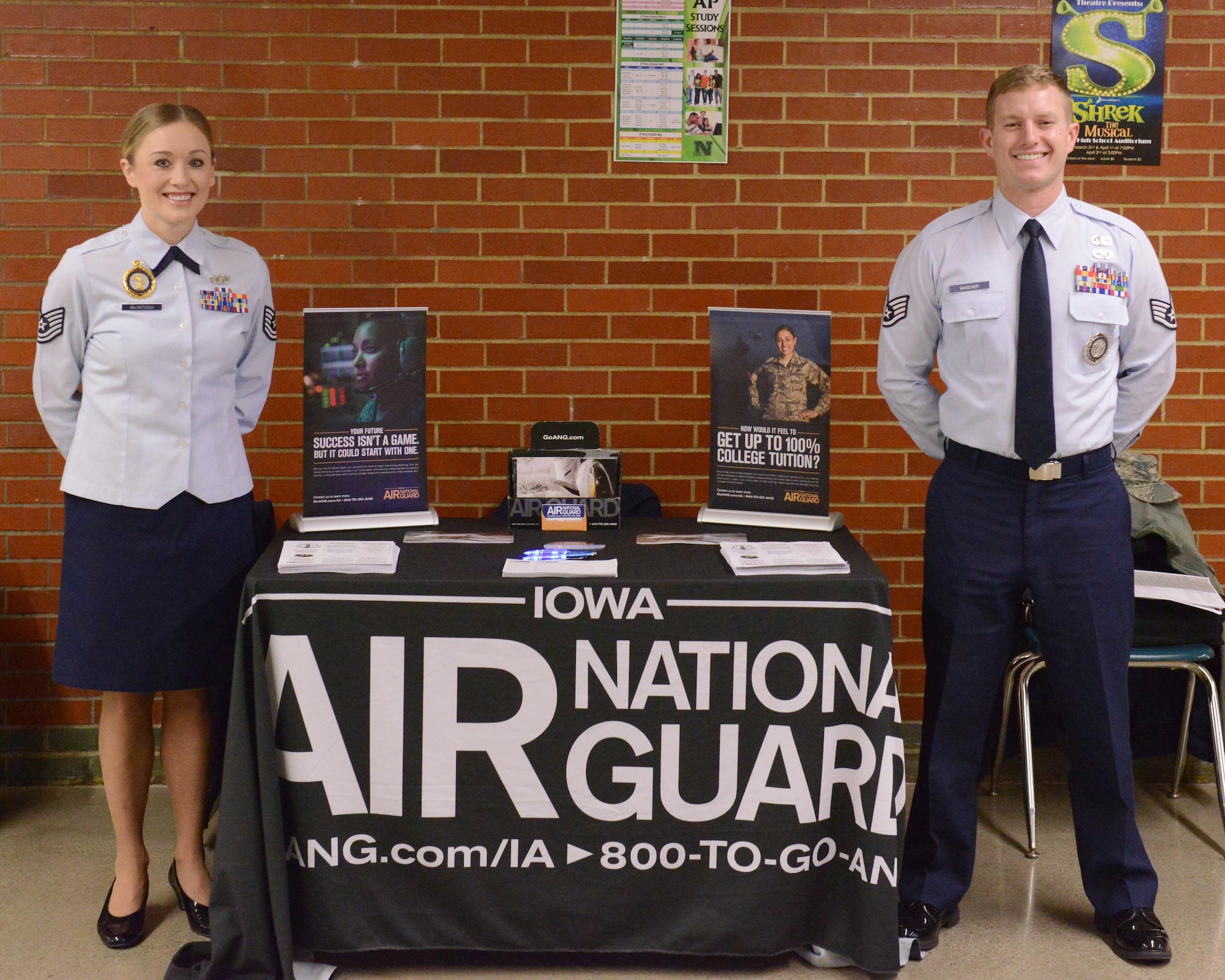 Tech. Sgt. Sabrina Mcintosh and Staff Sgt. Austin Wascher, pose for a photo at the 132nd Wing’s recruitment table at the JROTC competition at North High School, Des Moines, Iowa on April 1, 2017. This was the first time that an Air Force recruiting team had attended the competition. (U.S. Air National Guard photo by Airman Katelyn Sprott)