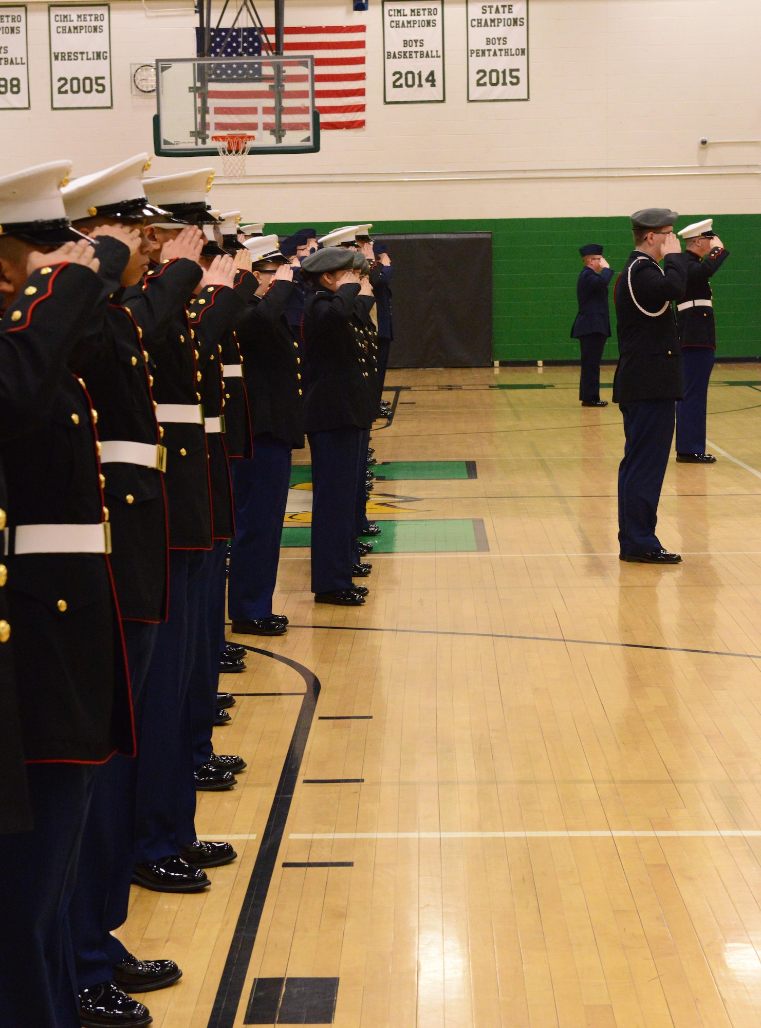 North High, Ottumwa, Davenport and Sioux City JROTC teams salute the flag during the National Anthem at the beginning of the JROTC competition at North High School, Des Moines, Iowa on April 1, 2017. This year there were only four teams due to schedule conflicts, next year there is projected to be 11. (U.S. Air National Guard photo by Airman Katelyn Sprott)