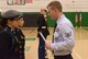 Staff Sgt. Austin Wascher inspects members of the Davenport JROTC team uniforms during the inspection portion of the JROTC competition at North High School, Des Moines, Iowa on April 1, 2017. Davenport took overall first place due to their drill and uniform sharpness. (U.S. Air National Guard photo by Airman Katelyn Sprott)