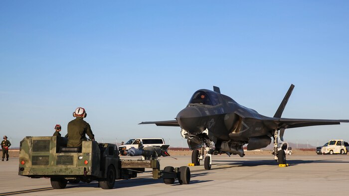 Marines with Marine Fighter Attack Squadron (VMFA) 211 prepare to conduct a hot load on an F-35B Lightning II at Marine Corps Air Station Yuma, Ariz., April 4.  Marines with VMFA-211 along with Marine Aviation Weapons and Tactics Squadron (MAWTS) 1, conducted hot loads during the semiannual Weapons and Tactics Instructor Course (WTI) 2-17. Lasting seven weeks, WTI is a training event hosted by MAWTS-1 that provides standardized advanced and tactical training and certification of unit instructor qualifications to support Marine aviation training and readiness.
