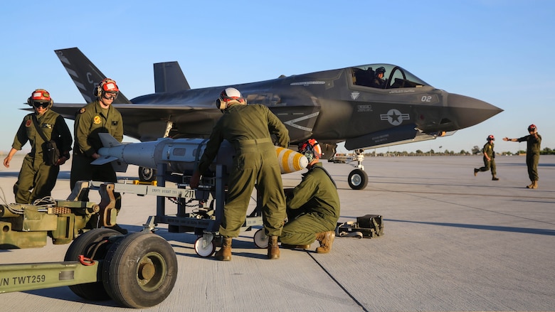 Marines with Marine Fighter Attack Squadron (VMFA) 211 prepare to conduct a hot load on an F-35B Lightning II at Marine Corps Air Station Yuma, Ariz., April 4.  Marines with VMFA-211 along with Marine Aviation Weapons and Tactics Squadron (MAWTS) 1, conducted  hot loads during the semiannual Weapons and Tactics Instructor Course (WTI) 2-17. Lasting seven weeks, WTI is a training event hosted by MAWTS-1 that provides standardized advanced and tactical training and certification of unit instructor qualifications to support Marine aviation training and readiness.