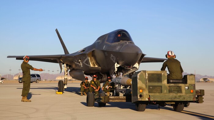 Marines with Marine Fighter Attack Squadron (VMFA) 211 prepare to conduct a hot load on an F-35B Lightning II at Marine Corps Air Station Yuma, Ariz., April 4.  Marines with VMFA-211 along with Marine Aviation Weapons and Tactics Squadron (MAWTS) 1, conducted hot loads during the semiannual Weapons and Tactics Instructor Course (WTI) 2-17. Lasting seven weeks, WTI is a training event hosted by MAWTS-1 that provides standardized advanced and tactical training and certification of unit instructor qualifications to support Marine aviation training and readiness.
