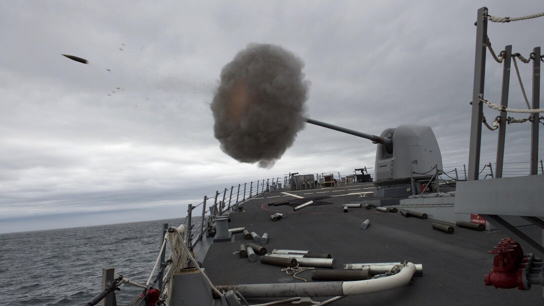 A MK 45 5-inch lightweight gun fires aboard the USS Carney as the ship conducts naval surface fire support qualifications off Cape Wrath, Scotland, April 3, 2017. The Carney is conducting a patrol in the U.S. 6th Fleet area of responsibility to support U.S. national security interests in Europe. Navy photo by Petty Officer 3rd Class Weston Jones