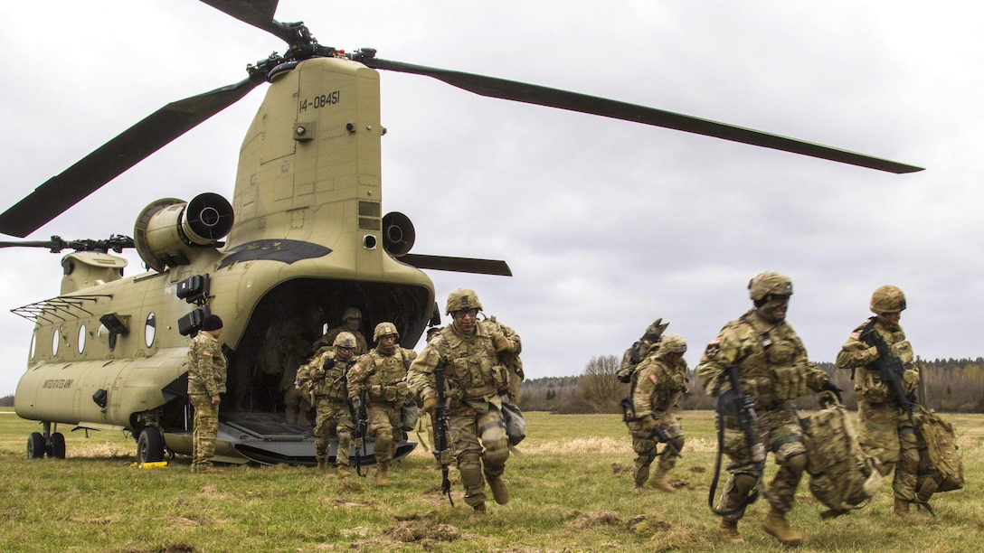 Soldiers exit a CH-47 Chinook helicopter during a training exercise at Grafenwoehr Training Area, Germany, April 6, 2017. Soldiers and aviators benefit from training together, which increases their knowledge and understanding of each other's roles. The soldiers are assigned to 3rd Squadron, 2nd Cavalry Regiment. Army photo by Spc. Thomas Scaggs
