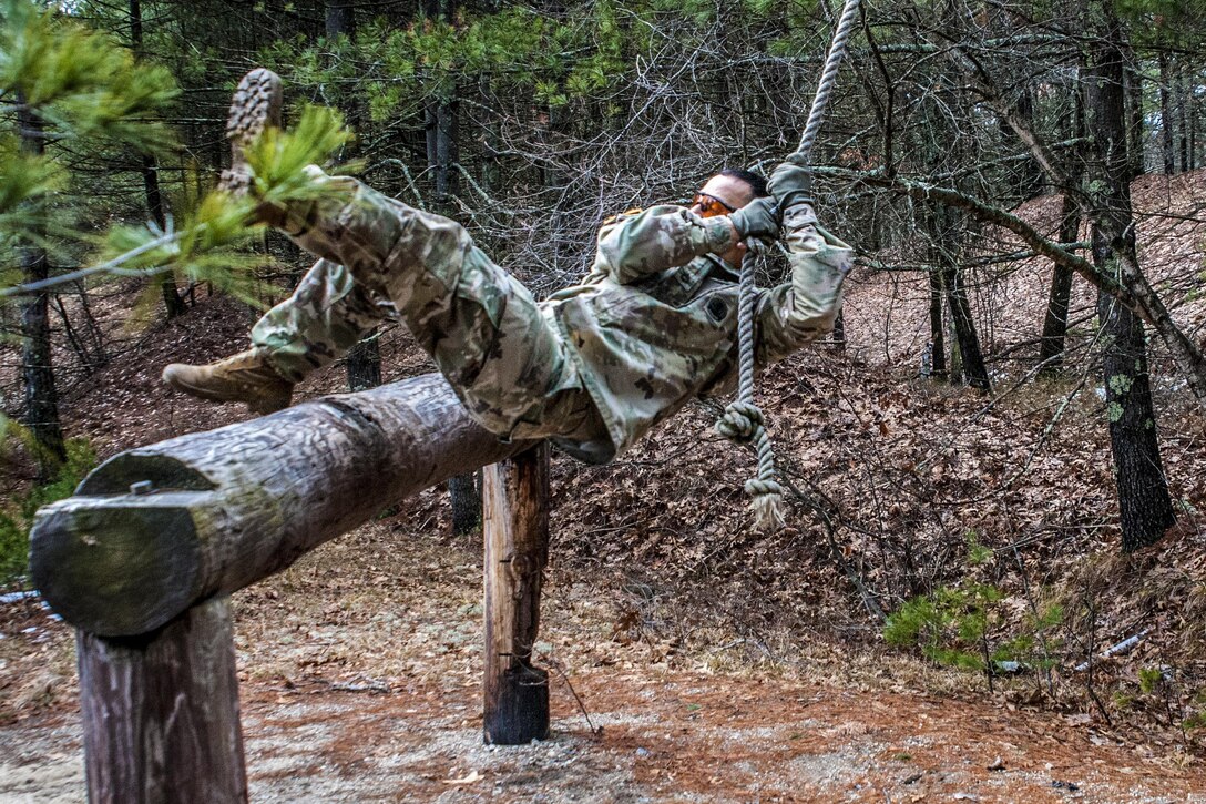A soldier uses a rope to swing across an obstacle during the Best Warrior Competition at Fort Devens, Mass., April 5, 2017. Army Reservists assigned to the 80th Training Command and 99th Regional Support Command participated in the event. Army photo by Staff Sgt. Timothy Koster