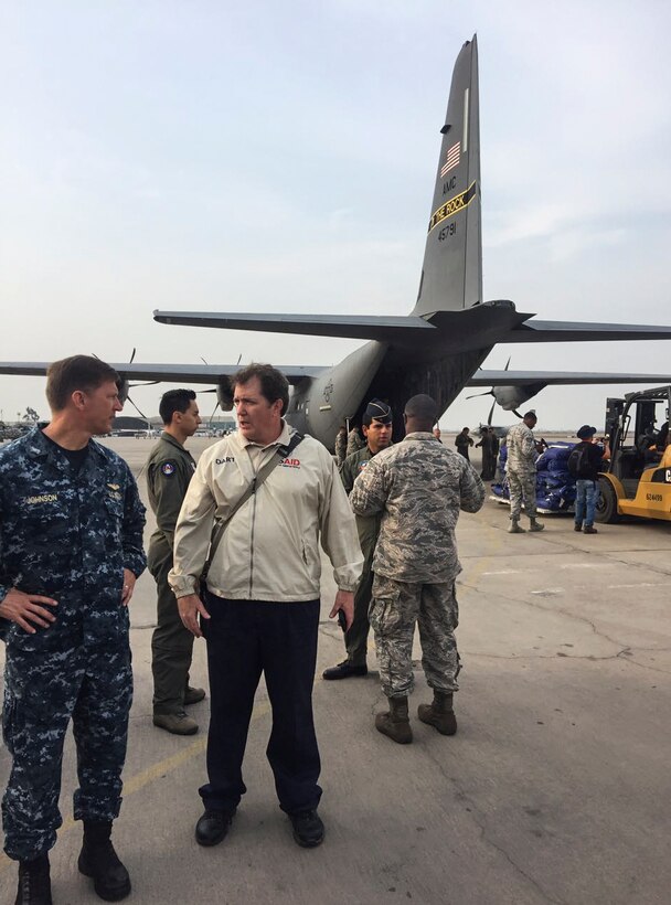 Navy Capt. H. Scott Johnson, left, and Tim Callaghan, Latin America regional chief, U.S. Agency for International Development, discuss flood relief plans on arrival at Grupo Ocho Peruvian Air Force Base, Peru, April 6, 2017. The U.S. military is assisting with relief efforts following torrential rains that flooded cities in northern Peru. DoD photo