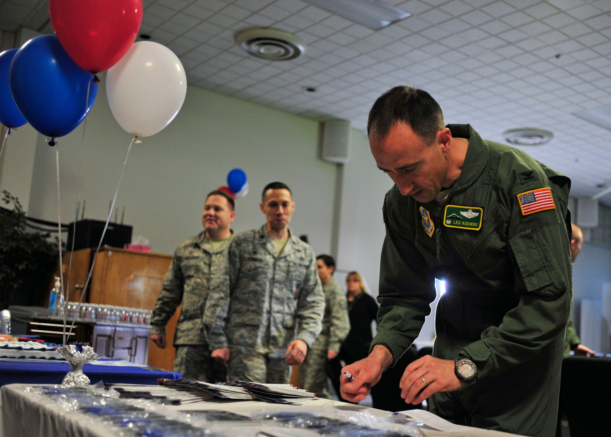 Col. Leonard Kosinski, 62nd Airlift Wing commander, fills out an Air Force Assistance Fund donation form at the AFAF kick-off event, April 6, 2017 at the McChord Field Chapel Support Center. Team McChord hopes to raise $51,576 in donations throughout the campaign, which lasts from April 10 through May 19. (U.S. Air Force photo/Staff Sgt. Whitney Amstutz)