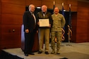 Doug Mecum, Deputy Regional Administrator for the National Oceanic and Atmospheric Association Fisheries in Alaska and Air Force Col. George T.M. Dietrich III, the JBER commander and 673d Air Base Wing commander awards Richard Graham, with the 673d Civil Engineer Squadron a plaque in recognition of JBER being the NOAA’s Species in the Spotlight Recovery Hero. NOAA chose to recognize JBER first because of the effectiveness of their ongoing partnership over the past thirty years.