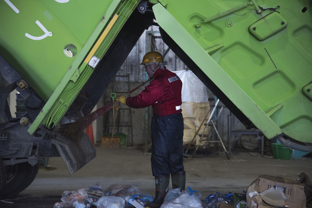 A Japanese national recycling center trash sorter clears out a dump truck at Misawa City, Japan, Mar. 20, 2017. Misawa Air Base, disposes of approximately 6,300 tons of trash a year with 31 percent of the trashrecycled. Currently the base is at a 31 percent recycling rate, with a goal to achieve a 65 percent recycling rate by 2020 (U.S. Air Force photo by Airman 1st Class Sadie Colbert)