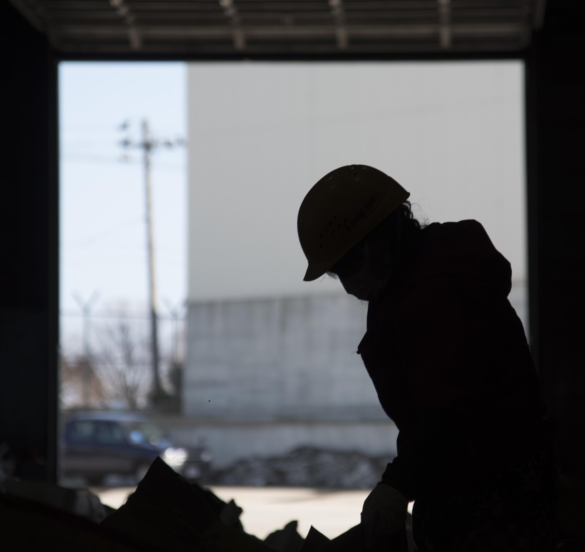 Chizu Yoko, a recycling center employee, piles cardboard at Misawa, Japan, March 20, 2017. Misawa Air Base has 10 workers assigned to collect, sort and transport trash. (U.S. Air Force photo by Airman 1st Class Sadie Colbert)
