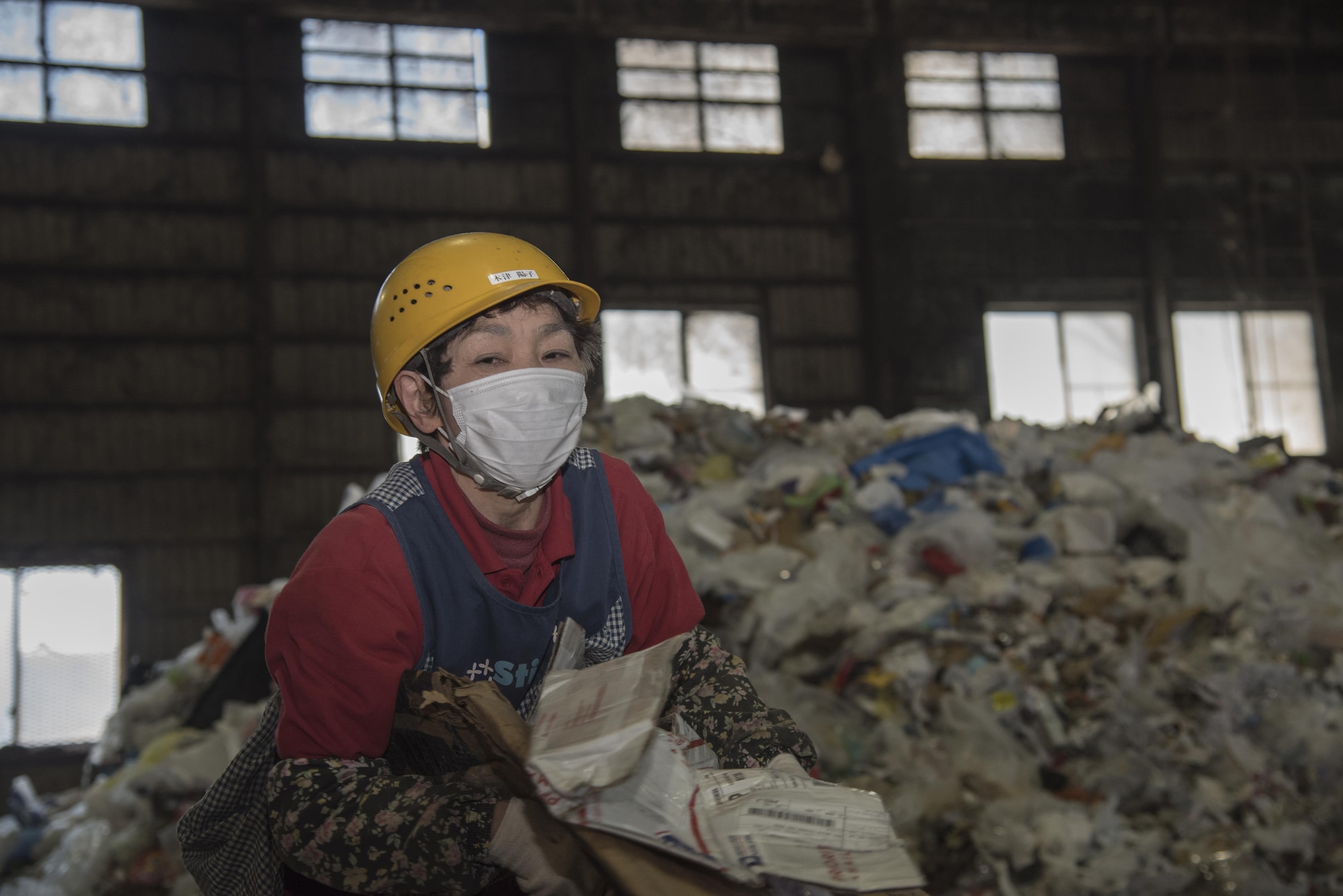 Chizu Yoko, a recycling center employee, begins separating trash received from military housing at Misawa, Japan, March 20, 2017. Currently Misawa recycles 31 percent their trash with the plan to increase to 65 percent by year 2018. (U.S. Air Force photo by Airman 1st Class Sadie Colbert)
