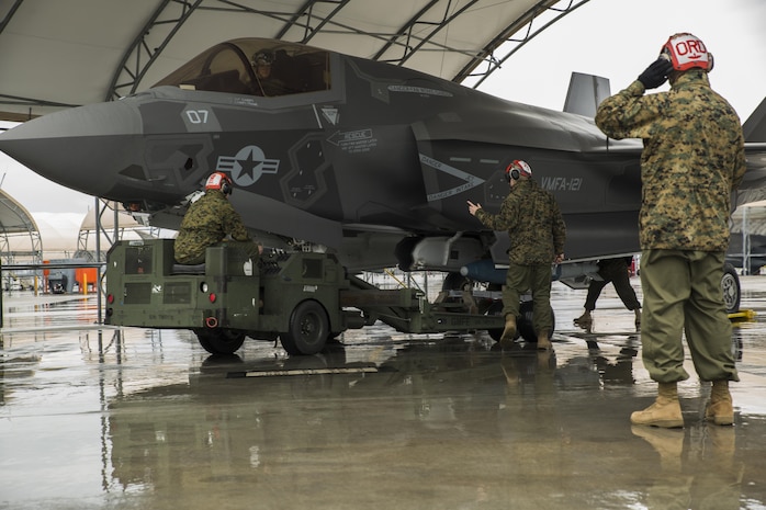 U.S. Marines with Marine Fighter Attack Squadron (VMFA) 121 load ordnance on an F-35B Lightning II aircraft during hot-reload training at Marine Corps Air Station Iwakuni, Japan, April 6, 2017. This signified the first time the squadron loaded ordnance onto a running F-35B Lightning II aircraft at the air station in order to prepare for real-world scenarios. (U.S. Marine Corps photo by Lance Cpl. Joseph Abrego)