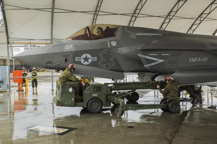 U.S. Marines with Marine Fighter Attack Squadron (VMFA) 121 load ordnance on an F-35B Lightning II aircraft during hot-reload training at Marine Corps Air Station Iwakuni, Japan, April 6, 2017. This signified the first time the squadron loaded ordnance onto a running F-35B Lightning II aircraft at the air station in order to prepare for real-world scenarios. (U.S. Marine Corps photo by Lance Cpl. Joseph Abrego)