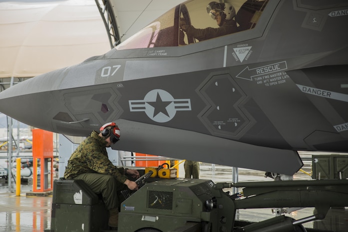 U.S. Marine Corps Cpl. Austin Crooks, ordnance technician with Marine Fighter Attack Squadron (VMFA) 121, loads ordnance onto an F-35B Lightning II during hot-reload training at Marine Corps Air Station Iwakuni, Japan, April 6, 2017. This signified the first time the squadron loaded ordnance onto a running F-35B Lightning II aircraft at the air station in order to prepare for real-world scenarios. (U.S. Marine Corps photo by Lance Cpl. Joseph Abrego)