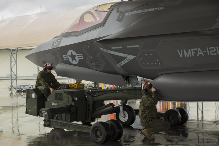 U.S. Marines with Marine Fighter Attack Squadron (VMFA) 121 load ordnance on an F-35B Lightning II aircraft during hot-reload training at Marine Corps Air Station Iwakuni, Japan, April 6, 2017. This signified the first time the squadron loaded ordnance onto a running F-35B Lightning II aircraft at the air station in order to prepare for real-world scenarios. (U.S. Marine Corps photo by Lance Cpl. Joseph Abrego)