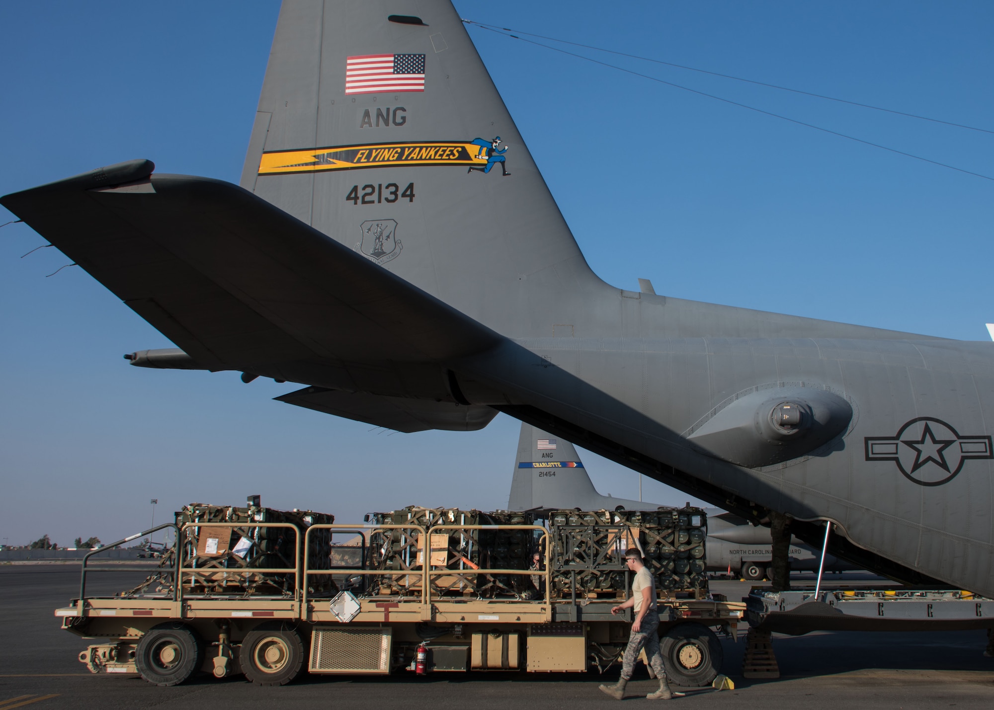 A 386th Expeditionary Logistics Readiness Squadron aerial porter inspects pallets on a K-loader at an undisclosed location in Southwest Asia March 27, 2017. The pallets were loaded onto a C-130H Hercules deployed with the Connecticut Air National Guard, which is currently flying its first C-130 deployment. (U.S. Air Force photo/Staff Sgt. Andrew Park)