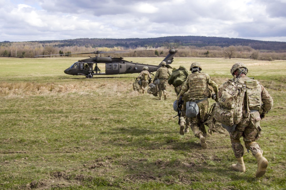 Soldiers rush to board a UH-60 Black Hawk helicopter during air assault training at Grafenwoehr Training Area, Germany, April 6, 2017. Army photo by Spc. Thomas Scaggs 