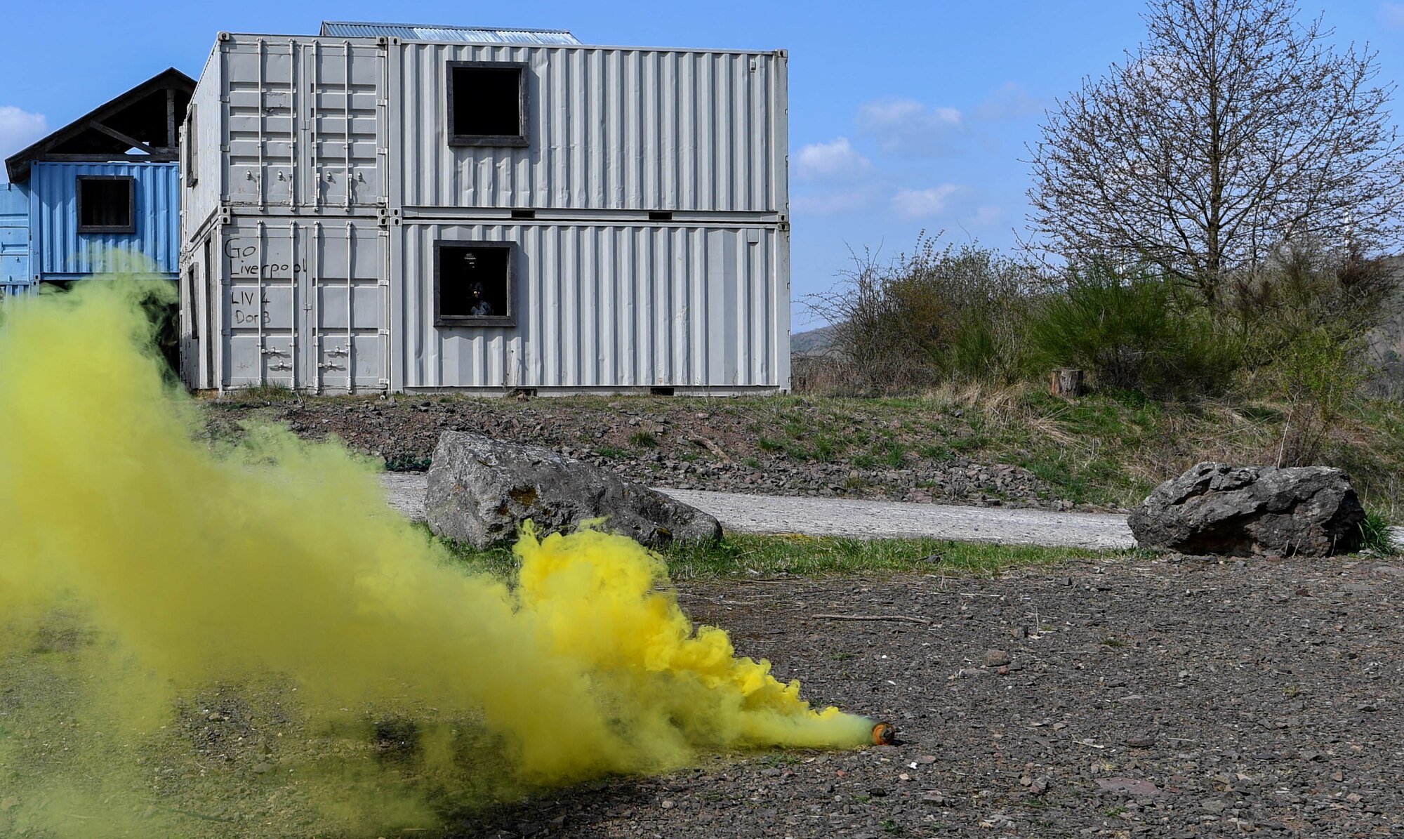 Yellow smoke billows out of smoke grenade during the urban operations portion of the 435th Security Forces Squadron’s Ground Combat Readiness Training Center’s Security Operations Course on U.S. Army Garrison Baumholder, Germany, April 4, 2017. The students had a mission to talk to a village leader and gain intelligence from him when they were attacked and had to neutralize the threat and make it back to their base. Airmen assigned to the 86th SFS, 422nd SFS, 100th SFS, and 569th U.S. Forces Police Squadron participated in the course. (U.S. Air Force photo by Senior Airman Tryphena Mayhugh)