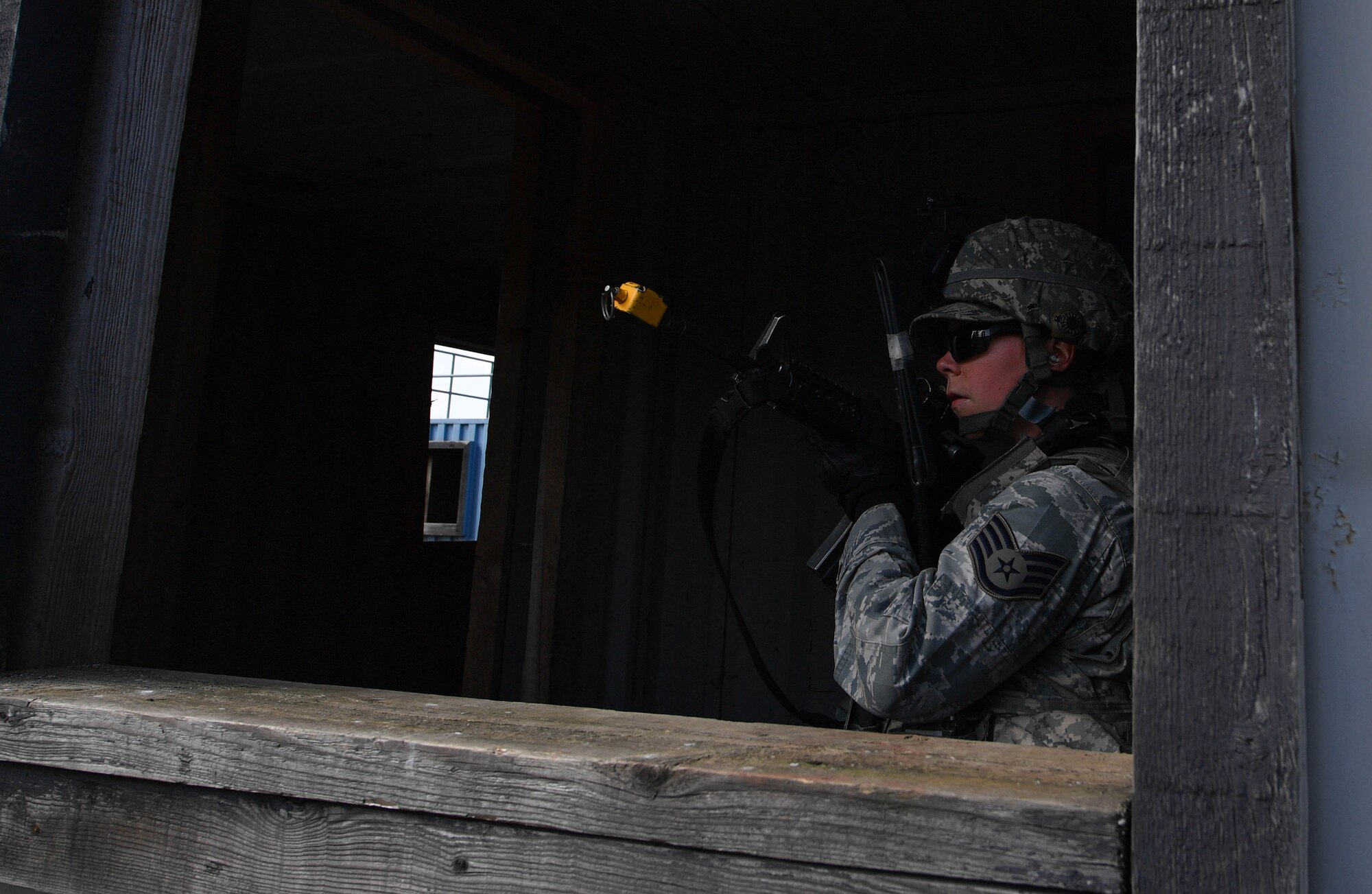 Staff Sgt. Katelyn McHale, 569th U.S. Forces Police Squadron desk sergeant, posts at a window to watch for opposing forces during the urban operations portion of the 435th Security Forces Squadron’s Ground Combat Readiness Training Center’s Security Operations Course on U.S. Army Garrison Baumholder, Germany, April 4, 2017. McHale and other students had a mission to tactically enter a mock village, gain intelligence from the village leader, and make it back to their base. Airmen assigned to the 86th SFS, 422nd SFS, 100th SFS, and 569th USFPS participated in the course. (U.S. Air Force photo by Senior Airman Tryphena Mayhugh)