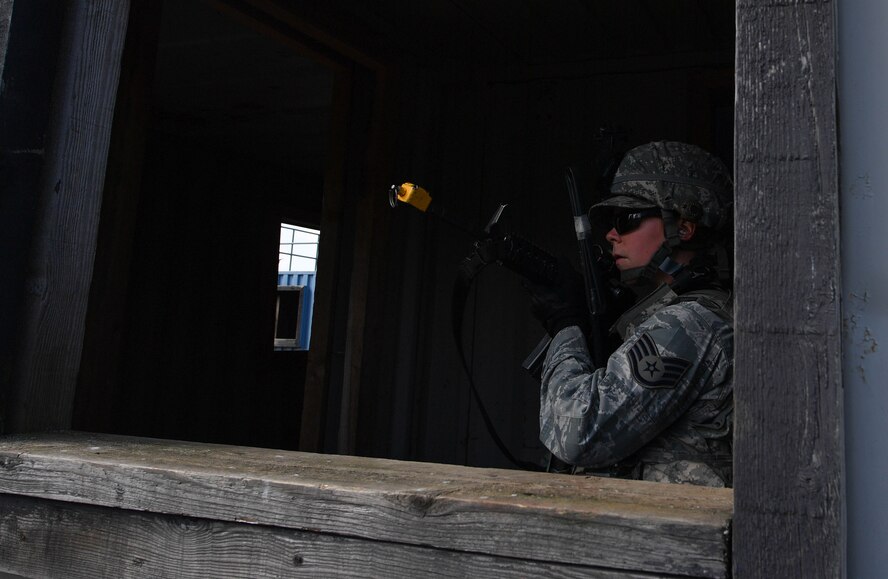 Staff Sgt. Katelyn McHale, 569th U.S. Forces Police Squadron desk sergeant, posts at a window to watch for opposing forces during the urban operations portion of the 435th Security Forces Squadron’s Ground Combat Readiness Training Center’s Security Operations Course on U.S. Army Garrison Baumholder, Germany, April 4, 2017. McHale and other students had a mission to tactically enter a mock village, gain intelligence from the village leader, and make it back to their base. Airmen assigned to the 86th SFS, 422nd SFS, 100th SFS, and 569th USFPS participated in the course. (U.S. Air Force photo by Senior Airman Tryphena Mayhugh)