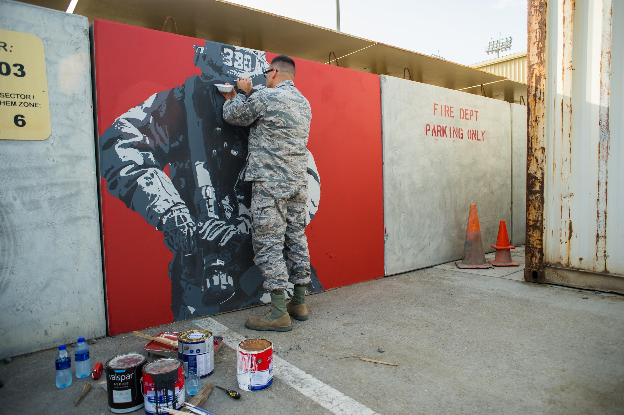 380th Expeditionary Civil Engineer Squadron fire fighter Staff Sgt. Jonathan paints a mural at an undisclosed location in Southwest Asia, March 6, 2017. Jonathan volunteered more than 150 hours of his time painting the mural. (U.S. Air Force photo/Senior Airman Tyler Woodward)
