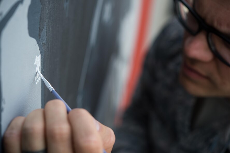 Staff Sgt. Jonathan, a 380th Expeditionary Civil Engineer Squadron firefighter, paints the final touches on a mural at an undisclosed location in Southwest Asia, March 6, 2017. Johnathan dedicated more than 150 hours during his off-duty time to complete the mural while supporting Combined Joint Task Force-Operation Inherent Resolve. (U.S. Air Force photo/Senior Airman Tyler Woodward)