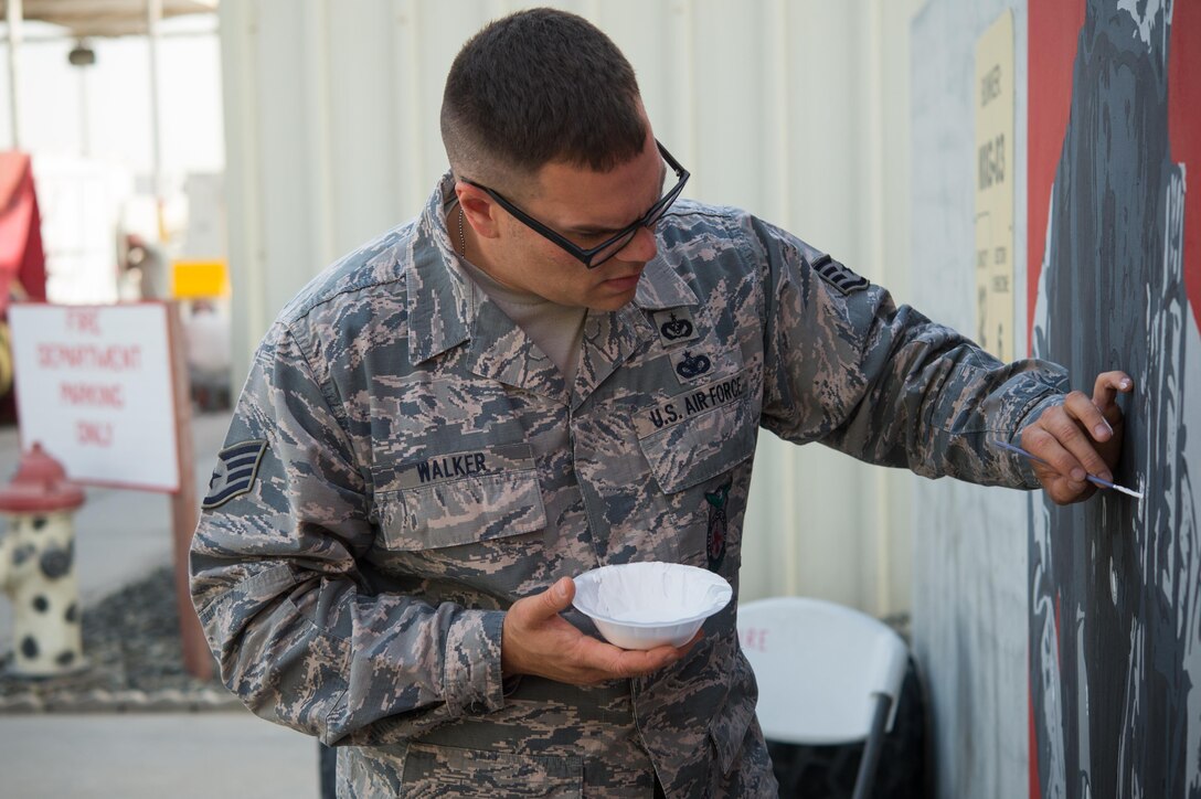 Staff Sgt. Jonathan, a 380th Expeditionary Civil Engineer Squadron firefighter, paints the final touches on a mural at an undisclosed location in Southwest Asia, March 6, 2017. Johnathan dedicated more than 150 hours during his off-duty time to complete the mural while supporting Combined Joint Task Force-Operation Inherent Resolve. (U.S. Air Force photo/Senior Airman Tyler Woodward)