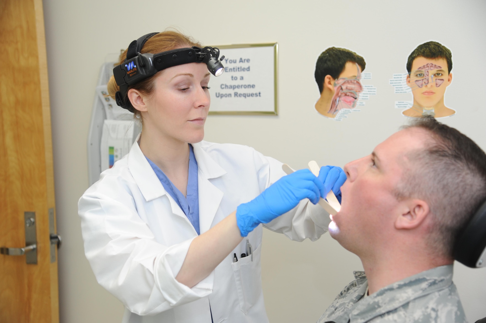 U.S. Air Force doctor (Maj.) Whitney Pafford, Chief, Head and Neck Surgery at Wright-Patterson Medical Center’s Department of Otolaryngology, checks a patient for irregularities or signs of cancer. The ENT clinic is hosting a walk-in head and neck cancer screening April 20, 2017 from 9 to 4. The screening for Active-duty military and Tricare beneficiaries will include an exam and information on different types of cancer and their symptoms. (U.S. Air Force photo/Tech Sgt. Scott Johnson)