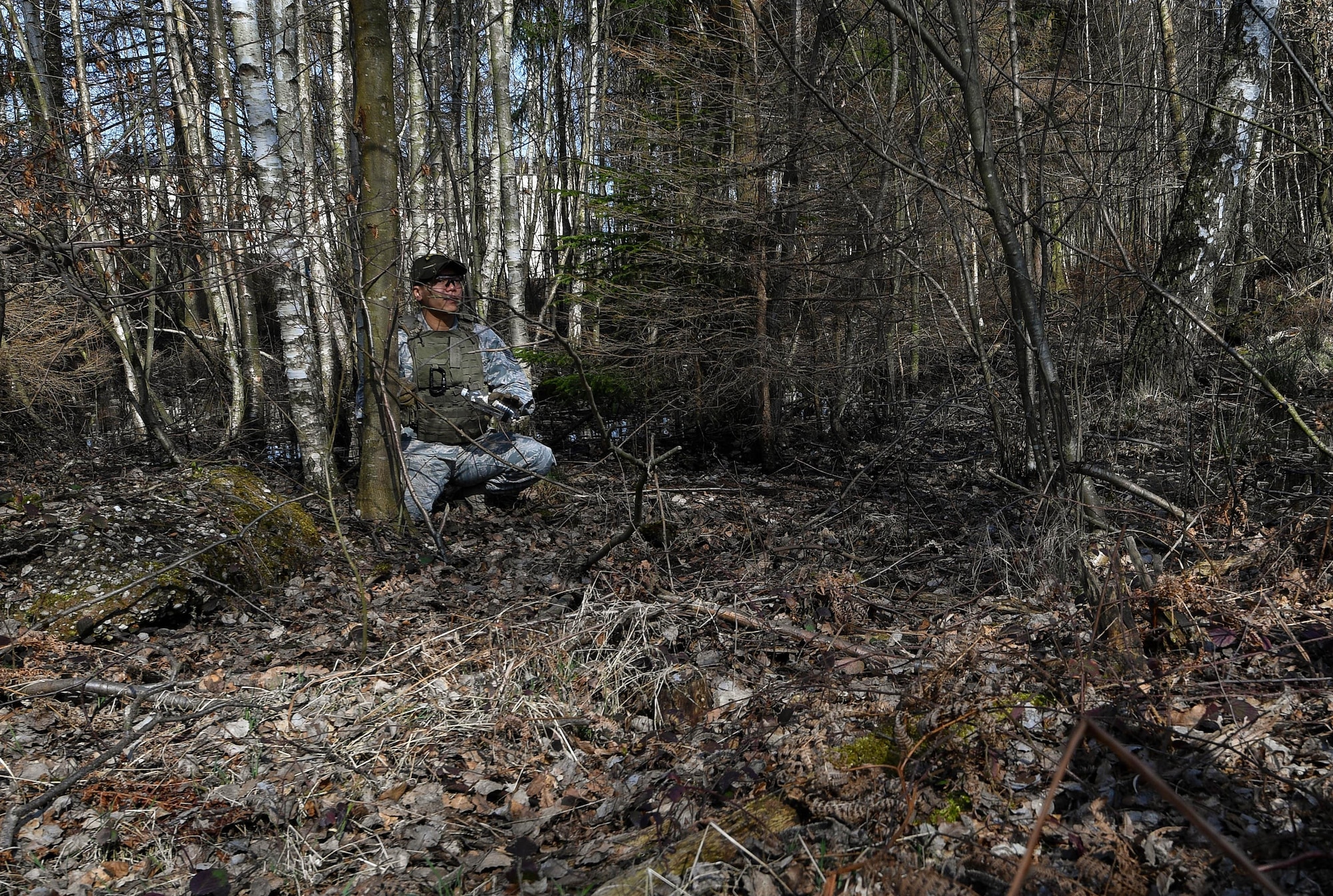 Staff Sgt. Jesse Sengsouk, 435th Security Forces Squadron’s Ground Combat Readiness Training Center instructor, shows students of the Security Operations Course a hidden improvised explosion device during the IED detection portion of the course on Ramstein Air Base, Germany, March 25, 2017. During the IED detection portion, the students marched through a wooded area and had to detect devices hidden along the way. Airmen assigned to the 86th SFS, 422nd SFS, 100th SFS, and 569th U.S. Forces Police Squadron participated in the course. (U.S. Air Force photo by Senior Airman Tryphena Mayhugh)