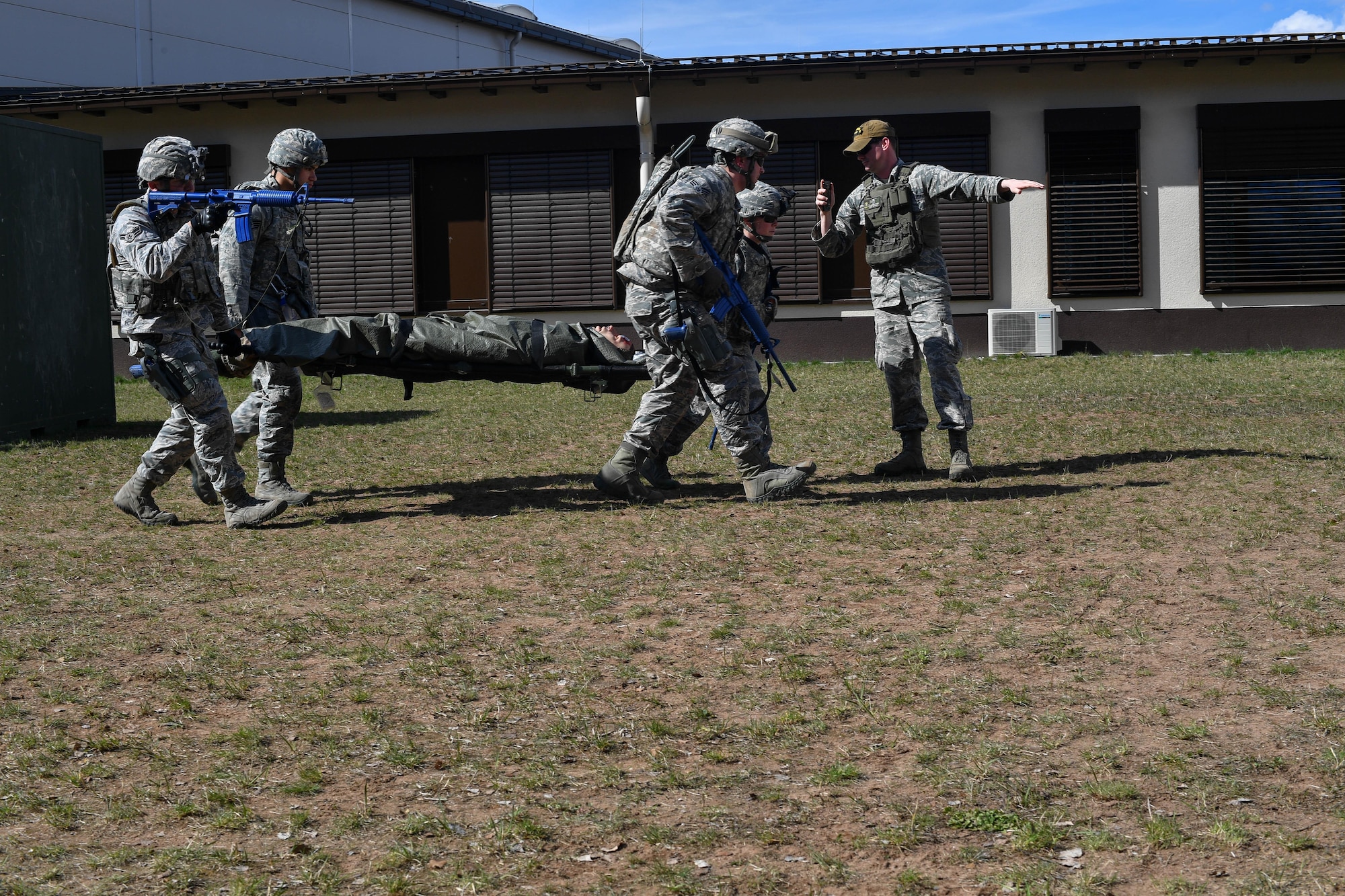 Students of the 435th Security Forces Squadron’s Ground Combat Readiness Training Center’s Security Operations Course carry a mock injured victim towards a simulated helicopter during the tactical combat casualty care portion of the course on Ramstein Air Base, Germany, March 30, 2017. The two-week course began March 24 and provides pre-deployment training to security forces Airmen who will be going downrange. Airmen assigned to the 86th SFS, 422nd SFS, 100th SFS, and 569th U.S. Forces Police Squadron participated in the course. (U.S. Air Force photo by Senior Airman Tryphena Mayhugh)