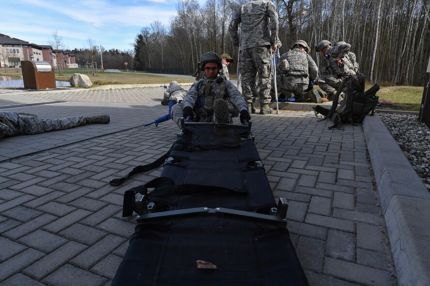 Senior Airman Nigel Crudgington, 100th Security Forces Squadron armor technician, sets up a litter to transport a simulated injured Airman during the tactical combat casualty care portion of the 435th Security Forces Squadron’s Ground Combat Readiness Training Center’s Security Operations Course on Ramstein Air Base, Germany, March 30, 2017. Airmen assigned to the 86th SFS, 422nd SFS, 100th SFS, and 569th U.S. Forces Police Squadron participated in the course. (U.S. Air Force photo by Senior Airman Tryphena Mayhugh)