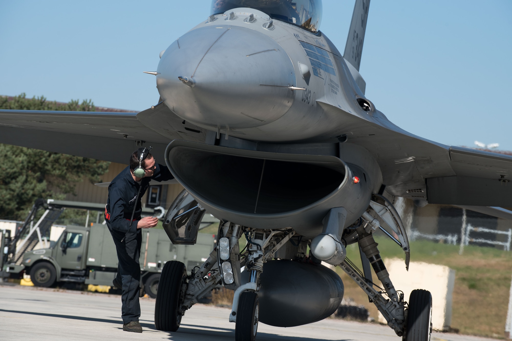 U.S. Air Force Staff Sgt. Eric Maxwell, 52nd Aircraft Maintenance Squadron dedicated crew chief checks the intake of the jet engine of an F-16 Fighting Falcon during a “hot pit” at Spangdahlem Air Base, Germany, March 28, 2017. A “hot pit” is the refueling of an aircraft while its engine is still running. During the refueling process, the aircraft is checked for safety items such as leaks and debris before returning to the air. (U.S. Air Force photo by Airman 1st Class Preston Cherry)