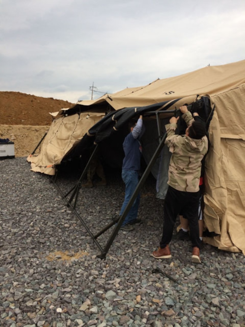 The Expeditionary Team works to set up a deployable warehouse, complete with Distribution Standard System, during Operation Pacific Reach.