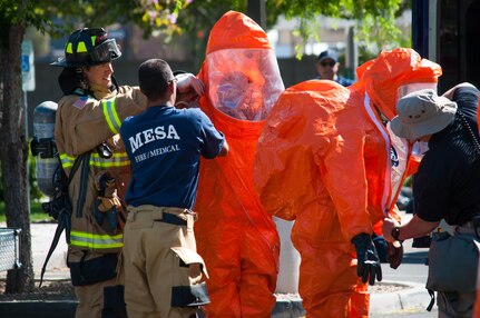 Firefighters from local departments assist members of the 91st Civil Support Team out of their hazardous materials suits after exiting a local animal hospital during an incident April 6, 2017. The Gilbert Fire Department requested the CST’s assistance after toxic gas was detected by their HAZMAT team during its initial entry into the facility.