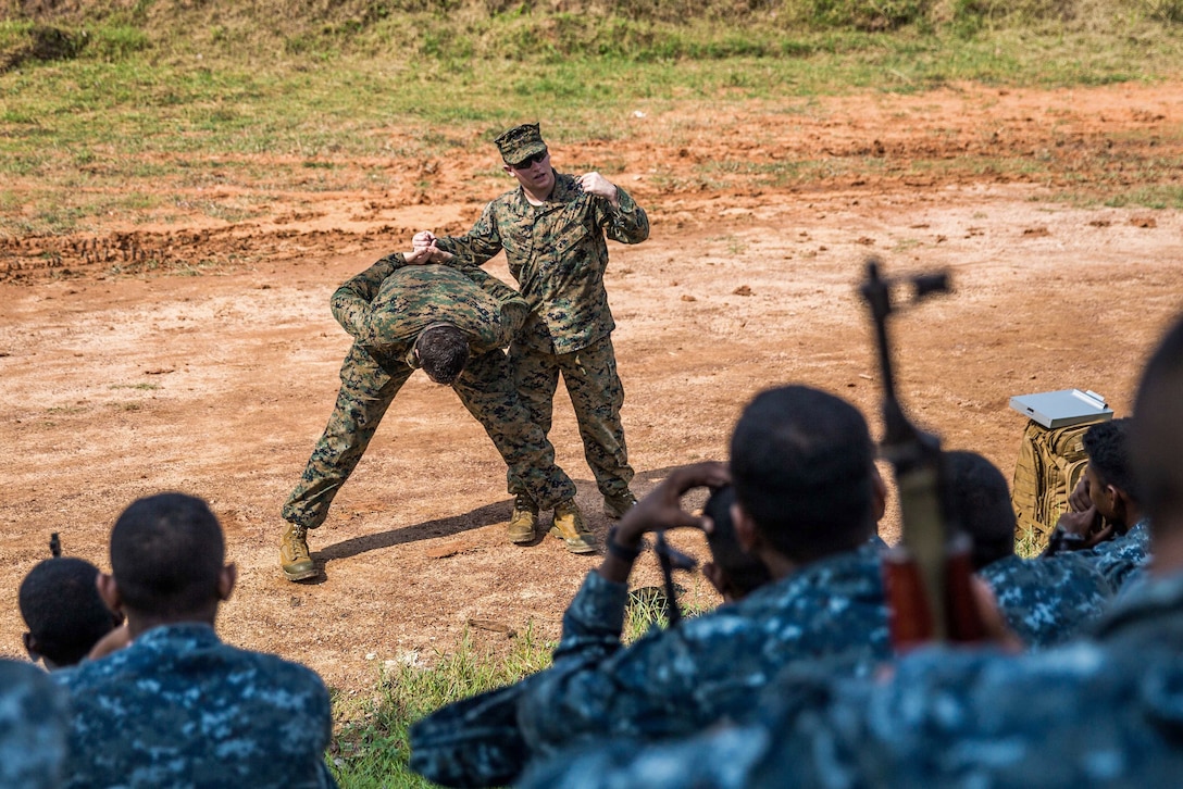U.S. Marine Cpl. Tanner Larson demonstrates detainee handling to Sri Lankan Marines during a military tactics training and exchange at Welissara Naval Base, Sri Lanka, March 29, 2017. Larson is a military policeman assigned to the 11th Marine Expeditionary Unit. During the training, Sri Lankan Marines had the opportunity to experience a wide variety of U.S. military tactics to include: squad-sized patrolling and rushing of enemy objectives, tactical casualty care, convoy operations, as well as humanitarian assistance and disaster relief scenarios. Marine Corps photo by Cpl. Devan K. Gowans