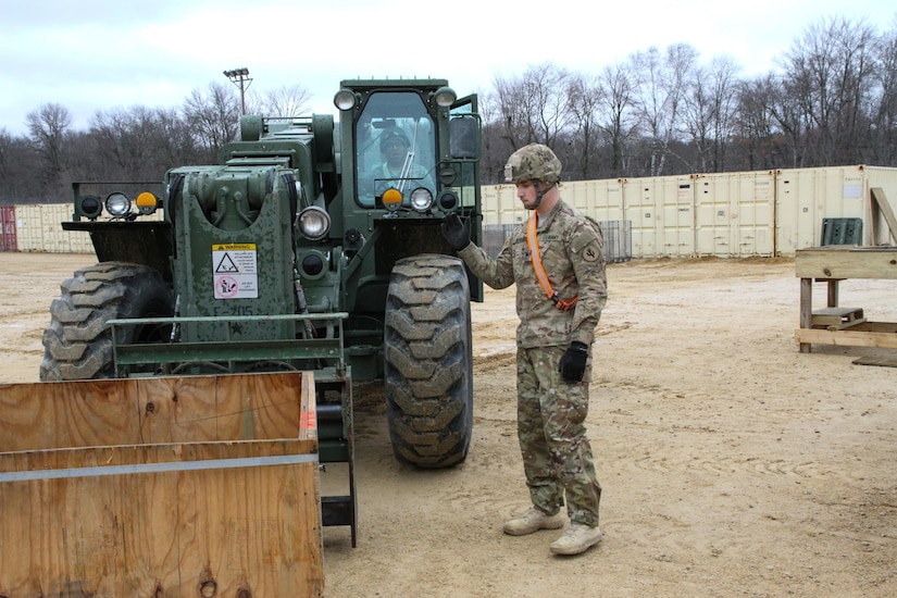 U.S. Army Reserve Spc. Josh Kohon, motor transport operator, guides Spc. Miguel Pabon, ammunition handler, to move a container while combining spent ammunition for turn in during Operation Cold Steel at Fort McCoy, Wis., March 30, 2017. Operation Cold Steel is the U.S. Army Reserve's crew-served weapons qualification and validation exercise to ensure that America's Army Reserve units and Soldiers are trained and ready to deploy on short-notice and bring combat-ready and lethal firepower in support of the Army and our joint partners anywhere in the world. (U.S. Army Reserve photo by Staff Sgt. Debralee Best, 84th Training Command)