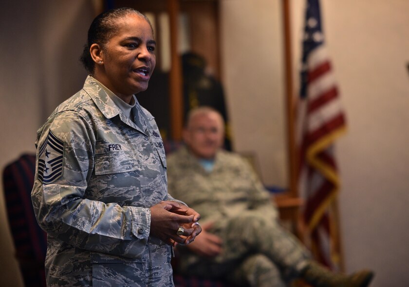 Chief Master Sgt. Shelina Frey, Air Mobility Command command chief, takes time during her visit with the 932nd Airlift Wing, April 1, 2017, to speak at the newcomers briefing. Col. Jonathan Philebaum, commander, 932nd AW, seated, listened as Frey discussed how the lines between active duty and reserve just aren't there anymore.  (U.S. Air Force photo by Tech. Sgt. Christopher Parr)