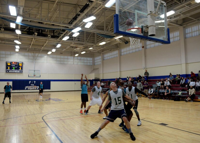 Multiple players from the 97th Wing Staff Agencies and 97th Logistics Readiness Squadrons compete during the 2017 Altus Air Force Base Basketball championship, April 4, 2017, at Altus AFB, Oklahoma. The Fitness Center offers several sports throughout the year as a way to support Airmen morale and comradery. (U.S. Air Force Photo by Airman 1st Class Jackson N. Haddon/Released).