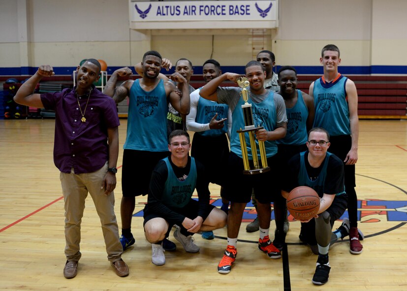 The 97th Logistics Readiness Squadron team poses for a photo after winning the 2017 Altus Air Force Base Basketball championship, April 4, 2017, at Altus Air Force Base, Oklahoma. The Fitness Center offers several sports throughout the year as a way to support Airmen morale and comradery. (U.S. Air Force Photo by Airman 1st Class Jackson N. Haddon/Released).