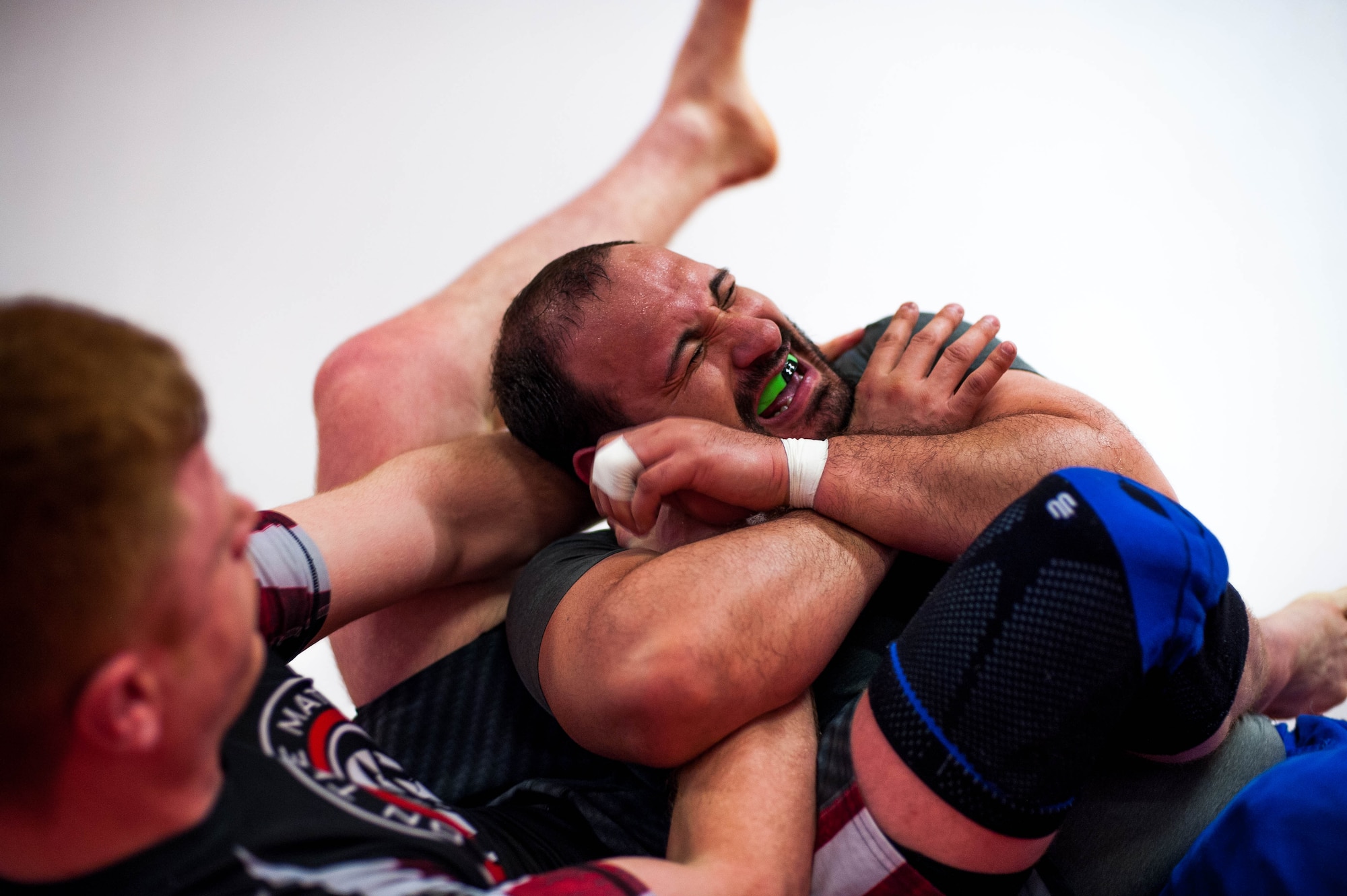 Giovani Gironda, Defense Logistics Agency contracting officer, attempts to resist an arm lock from U.S. Air Force Staff Sgt. Joseph Everett, 86th Aircraft Maintenance Squadron aerospace maintenance craftsman, left, during Brazilian Jiu Jitsu training on Ramstein Air Base, Germany, April 5, 2017. BJJ is a grappling style martial art that is designed to teach a smaller person how to defend themselves against a larger person. (U.S. Air Force photo by Senior Airman Devin Boyer/Released)