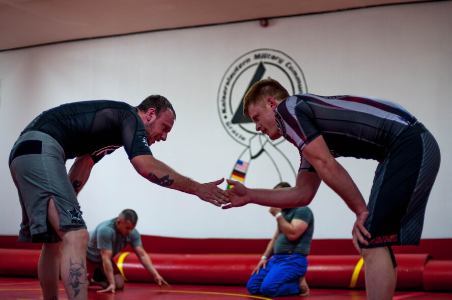 Mike Suttor slaps hands with U.S. Air Force Staff Sgt. Joseph Everett, 86th Aircraft Maintenance Squadron aerospace maintenance craftsman, during Brazilian Jiu Jitsu training on Ramstein Air Base, Germany, April 5, 2017. Before each match, opponents will slap hands and bump fists as a promise to keep the match friendly and fair in a form of mutual respect. (U.S. Air Force photo by Senior Airman Devin Boyer/Released)
