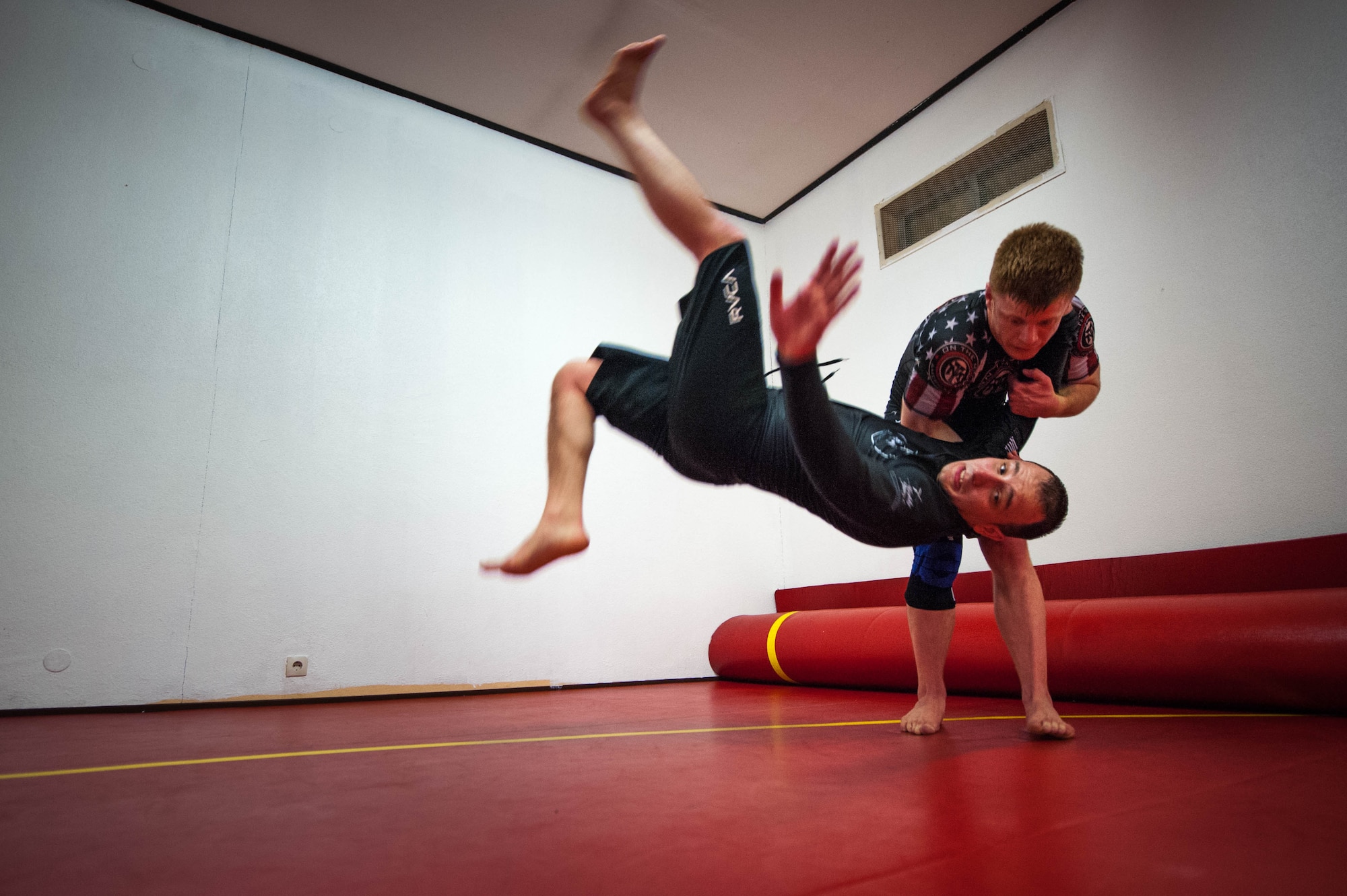 U.S. Air Force Staff Sgt. Joseph Everett, 86th Aircraft Maintenance Squadron aerospace maintenance craftsman, flips Emir Mulic over his shoulder during Brazilian Jiu Jitsu training on Ramstein Air Base, Germany, April 5, 2017. The one arm shoulder throw is a Judo move traditionally named Ippon Seoi Nage. (U.S. Air Force photo by Senior Airman Devin Boyer/Released)
