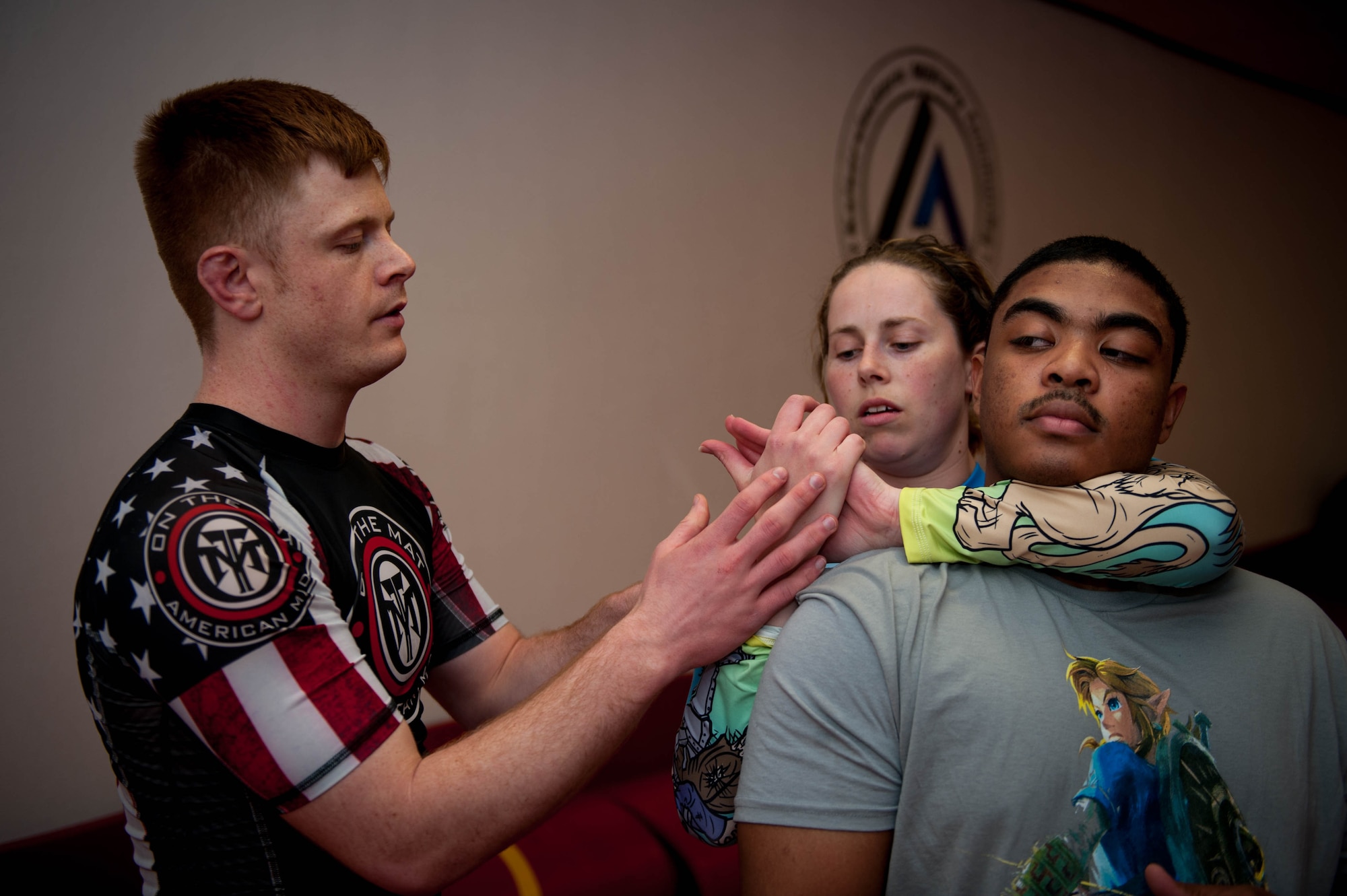 U.S. Air Force Staff Sgt. Joseph Everett, 86th Aircraft Maintenance Squadron aerospace maintenance craftsman, teaches Samantha Lamm and Senior Airman Rashid Edgington, 86th AMXS commander support staff, how to perform a move during Brazilian Jiu Jitsu training on Ramstein Air Base, Germany, April 5, 2017. Everett was showing Lamm how to secure her grip correctly to control her training partner. (U.S. Air Force photo by Senior Airman Devin Boyer/Released)