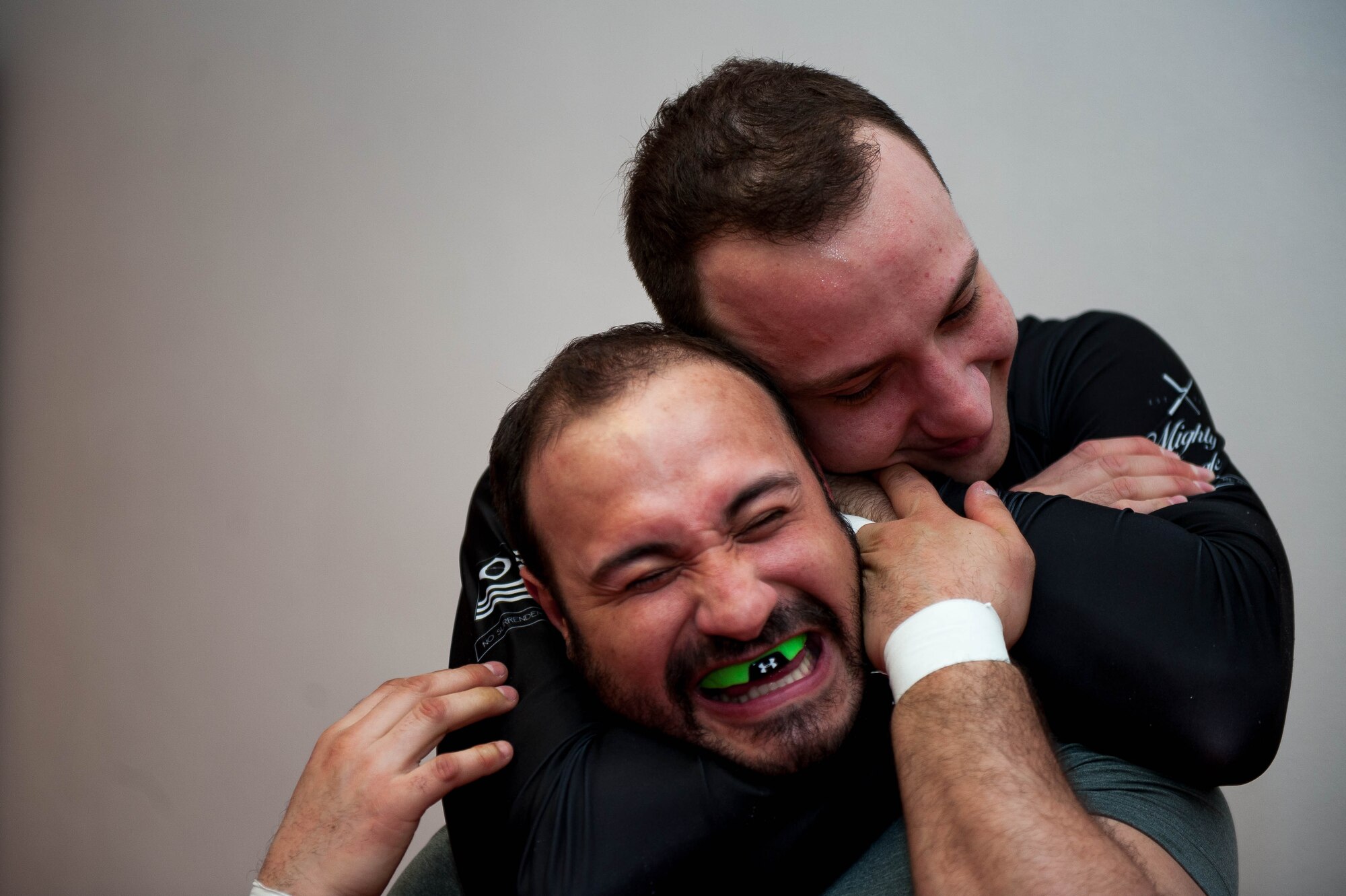 Emir Mulic performs the Mata Leão choke while jokingly hugging Giovani Gironda, Defense Logistics Agency contracting officer, during Brazilian Jiu Jitsu training on Ramstein Air Base, Germany, April 5, 2017. Mata Leão, also known as the rear naked choke, means “lion killer” in Portuguese. (U.S. Air Force photo by Senior Airman Devin Boyer/Released)