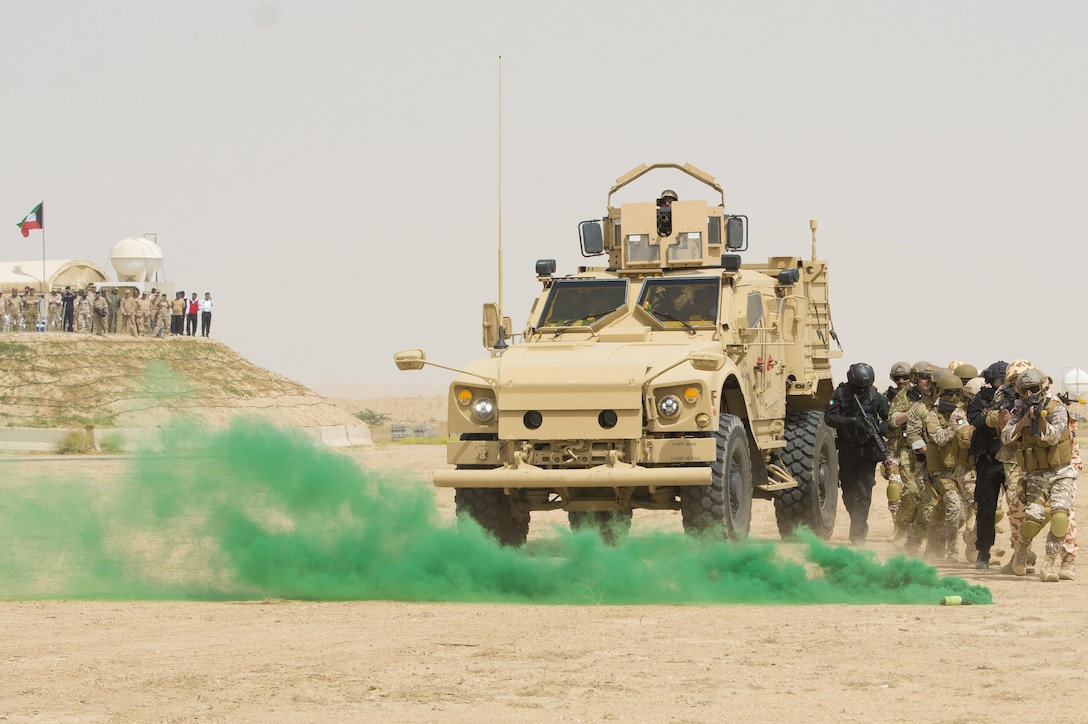 Kuwait- A large crowd of foreign and U.S. dignitaries view teams from their combined special forces- Qatar, Kuwait, Saudi Arabia and the United States, during an explosive training mission  proving the successful interoperability of both land and air assets as well as highlighting the vast skills of the varied partner nations part of Operation Eagle Resolve, April 2. 
(Photo by Army Sgt. 1st Class Suzanne Ringle/Released)