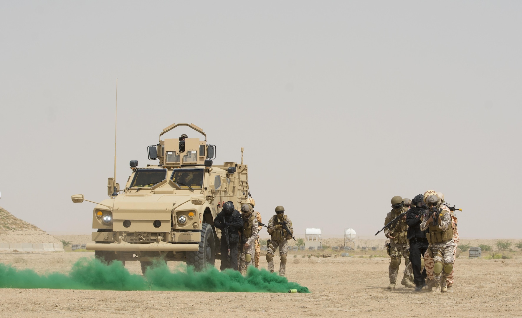 Kuwait- A large crowd of foreign and U.S. dignitaries view teams from their combined special forces- Qatar, Kuwait, Saudi Arabia and the United States, make their way to their intended target during an explosive training mission  proving the successful interoperability of both land and air assets as well as highlighting the vast skills of the varied partner nations part of Operation Eagle Resolve, April 2. 
(Photo by Army Sgt. 1st Class Suzanne Ringle/Released)