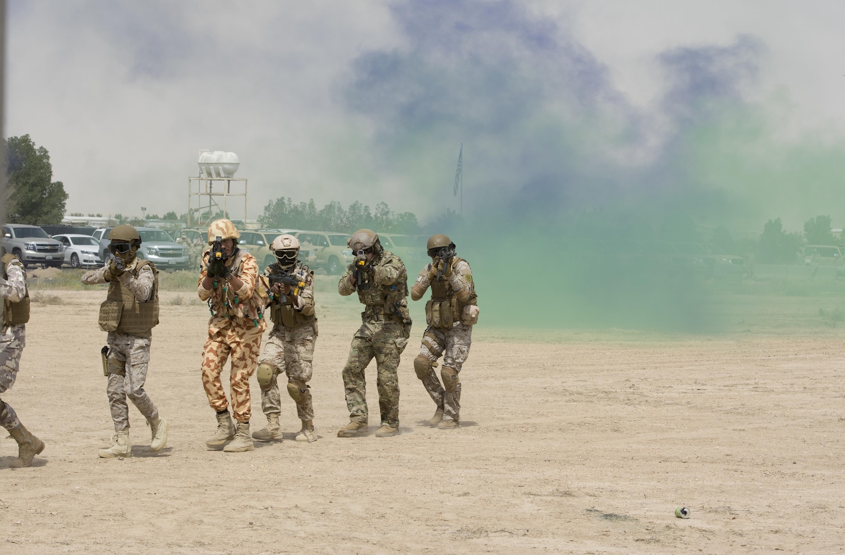 Kuwait- A large crowd of foreign and U.S. dignitaries’ view teams comprised of their combined special forces emerge from a purple and green smoke screen during an explosive training mission demonstrating the successful interoperability of Qatar, Kuwait, Saudi Arabia and the United States as partner nations and part of Operation Eagle Resolve involving both land and air elements, April 2. 
(Photo by Army Sgt. 1st Class Suzanne Ringle/Released)