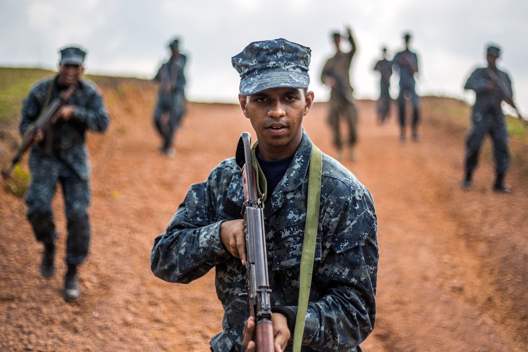 A Sri Lankan Marine takes point of his squad during the patrolling portion of a military tactics training and exchange, part of a theater security cooperation engagement at Welissara Naval Base, Sri Lanka, March 29, 2017. Marine Corps photo by Cpl. Devan K. Gowans