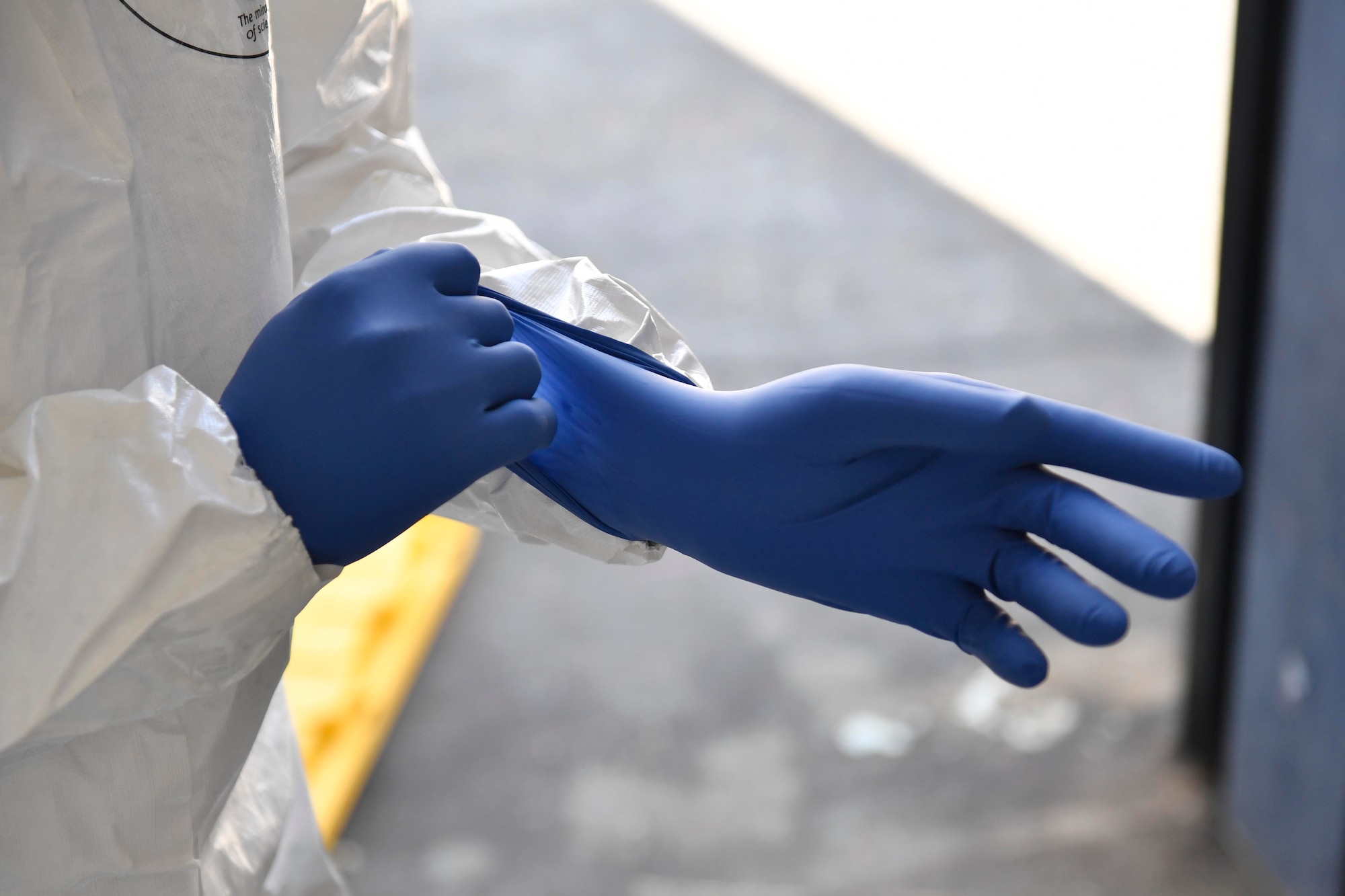 James Bundo, Medical University of South Carolina team leader, puts on a glove during a communicable disease exercise at the Charleston, S.C. Federal Law Enforcement compound April 4, 2017. The exercise, the first of its kind here, tested communication procedures and the integration of federal, state, local and private industry partners while analyzing response capabilities if an infected person needed to be transported from a vessel to the Port of Charleston. 